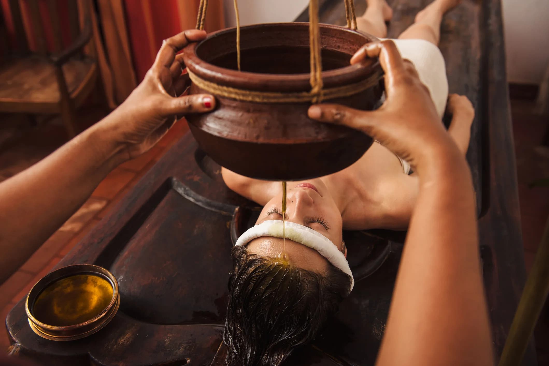 Ayurvedic oil flow therapy on forehead